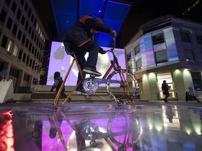 8-year-old Clive Harazny rides a stationary bike at Eric Hill's installation titled, Raven, It's a Great Feeling during Regina's first Nuit Blanche event held in and around Victoria Park on Saturday, Sept. 29, 2018. Nuit Blanche — which means 'Sleepless Night' — is a festival held across the globe, varying from place to place while maintaining the same two key principles: It's free and it's at night.