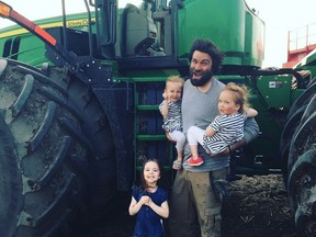 Organic farmer Travis Heide poses with his daughters, left to right, Adora, 9, and twins Audrey, and Gia, 6, near Melfort, Sask., in this undated handout photo.