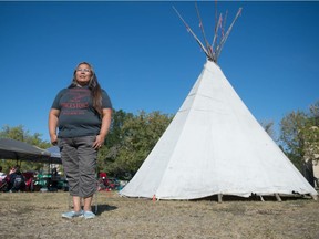 Joely BigEagle-Kequahtooway stands next to a teepee at Dewdney Park during a barbecue to push for the park's name to be changed to Buffalo Meadows.