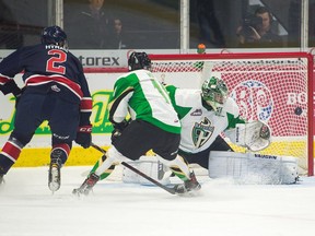 Regina Pats defenceman Aaron Hyman (2) puts the puck past Prince Albert Raiders goalie Ian Scott during WHL action at the Brandt Centre on Saturday.