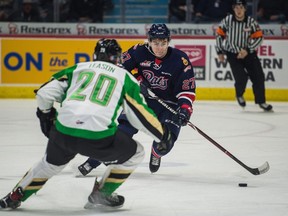 Regina Pats defenceman Nikita Sedov tries to go around Prince Albert Raiders forward Brett Leason during WHL action at the Brandt Centre on Saturday.