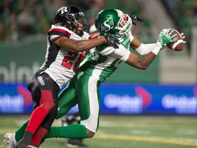 Roughriders receiver Kyran Moore (85) catches a long pass during a game against the Ottawa Redblacks at Mosaic Stadium. Pursuing him is Ottawa defensive back Corey Tindal Sr.