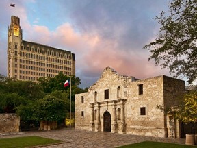 The Alamo is dwarfed by the Emily Hotel in San Antonio. Courtesy visitsanantonio.com