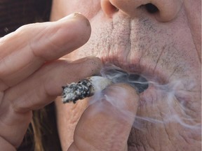 A man smokes marijuana in Kamloops, B.C. on Wednesday, Oct. 17, 2018.