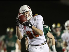 Hunter Karl hauls in a pass for the University of Calgary Dinos in their 58-6 victory over the visiting University of Regina Rams on Friday.