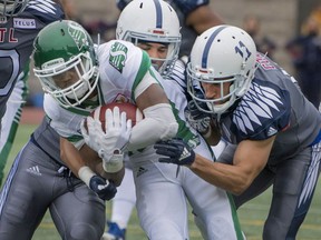 Saskatchewan Roughriders receiver Kyran Moore (middle) was more than a handful for the Montreal Alouettes on Sunday.