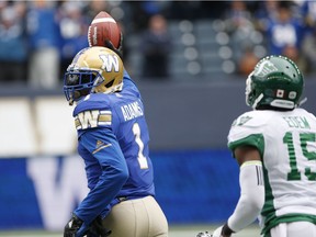 Winnipeg Blue Bombers' Darvin Adams (1) celebrates his touchdown as he runs the ball in against Saskatchewan Roughriders' Mike Edem (15) during the first half of CFL action in Winnipeg Saturday, October 13, 2018.