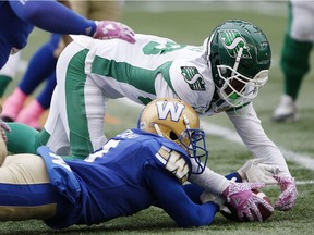 The Winnipeg Blue Bombers' Kevin Fogg, bottom, recovers a fumble by the Saskatchewan Roughriders' Caleb Holley, top, on Saturday. That was one of the Riders' four turnovers in a 31-0 loss.
