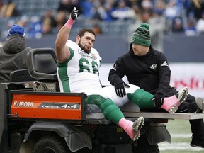 Saskatchewan Roughriders guard Dariusz Bladek is taken to the dressing room after suffering a knee injury Saturday against the host Winnipeg Blue Bombers.