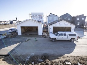 A pair of back alley garages under construction in southeast Regina.