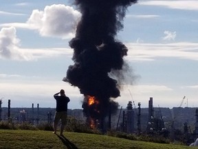 A fire and plume of smoke rises from an Irving Oil refinery following reports of an explosion in Saint John, N.B., on Monday, October 8, 2018.
