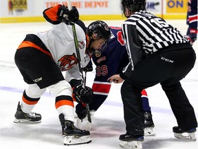 Cole Sillinger of the Medicine Hat Tigers, left, faces off against Garrett Wright of the Regina Pats during WHL action on Friday in Regina.