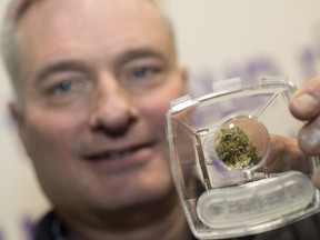 Allen Kilback, owner of Eden, holds up a viewing and smelling container that customers will be using to make their first ever legal cannabis purchases.  This weed is Royal High Great White Shark from United Greeneries located in British Columbia.