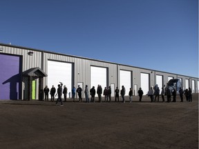 A lineup of customers wait for Eden, a legal shop set up to sell weed, to open just west of Pilot Butte on Wednesday, Oct. 17, 2018.