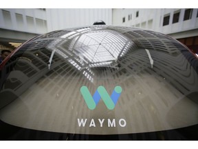 FILE - In this Dec. 13, 2016, file photo, a skylight is reflected in the rear window of a Waymo driverless car during a Google event in San Francisco. Google's robotic car spin-off Waymo is poised to become the first to test fully driverless vehicles on California's public roads.