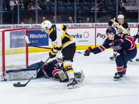 Regina Pats netminder Dean McNabb and defenceman Nikita Sedov try to stop Vinny Iorio of the Brandon Wheat Kings from scoring in WHL action at the Brandt Centre on Saturday.