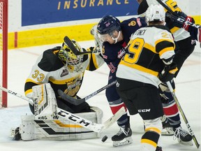 Regina Pats forward Nick Henry battles for a loose puck in front of Brandon Wheat Kings netminder Jiri Patera during WHL action on Saturday night at the Brandt Centre.