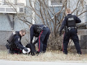 Members of the Regina Police Service take a suspect into custody on the 2900 block of Dewdney Avenue in Regina.