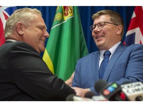 Premier of Ontario Doug Ford, left, shakes hands with Premier Scott Moe during a media event in Saskatoon on Thursday, October 4, 2018.