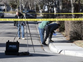 Regina police examine the scene of an Oct. 23 shooting on Sinton Avenue in Regina.