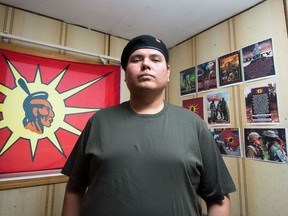 Chris Big Eagle, a member of the Cree Warriors Society, stands in his room in his home on the Ocean Man First Nation.