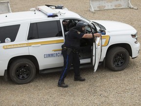 Members of the Commercial Vehicle Enforcement act out mock scenarios during a Ministry of Highways and Infrastructure event showcasing the tactical training Commercial Vehicle Enforcement officers are receiving prior to joining the provincial Protection and Response Team at a private range south west of Saskatoon, SK on Thursday, June 14, 2018.