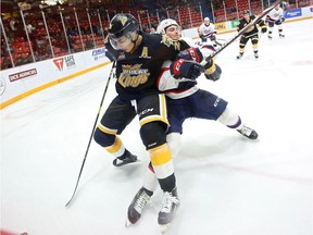 Linden McCorrister of the Brandon Wheat Kings keeps Logan Nijhoff of the Regina Pats away from the puck during WHL action at Westoba Place on Friday evening.