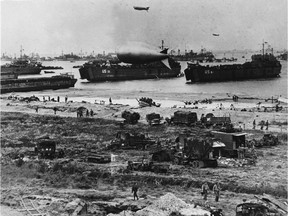 Troops disembark from landing crafts during D-Day on June 6, 1944 after Allied forces stormed the Normandy beaches.