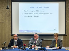 City of Regina executive director finance and corporate services Barry Lacey, left, city manager Chris Holden, centre, and director of finance June Schultz discuss the city budget with members of the media at Regina City Hall on Friday, Nov. 16, 2018.