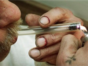 A man smokes a crack pipe. The Saskatchewan Health Authority will soon make safe inhalation kits available to people smoking crack.