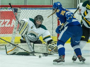 University of Regina Cougars netminder Jane Kish keeps a close eye on the puck Saturday as the UBC Thunderbirds' Hannah Koroll hovers around the crease at the Co-operators Centre. UBC won 2-1 in a shootout.