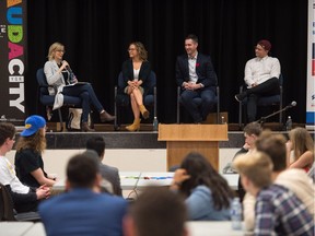 A panel of presenters sit on stage at Campus Regina Public during an event in which entrepreneurs spoke with students.