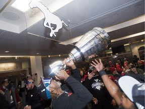 Calgary Stampeders receiver Bakari Grant, formerly of the Saskatchewan Roughriders, drinks from the Grey Cup on Sunday in Edmonton.