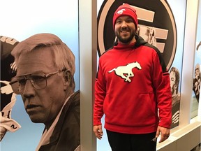 Calgary Stampeders running backs coach Marc Mueller is shown at Commonwealth Stadium during Grey Cup week, alongside a photo of his grandfather, Ron Lancaster.