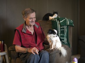 George Moffatt, left, along with his dog Kricket, in their home in the Glen Elm Trailer Park in Regina on Friday.