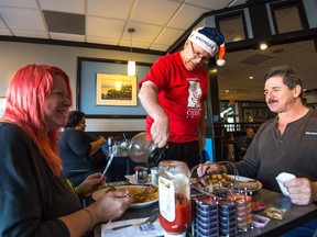 Rob Vanstone, centre, serves customers Faye Clark, right, and Ron Selinger at Nicky's Cafe last year at Coffee Day — an annual fundraiser for the Regina Leader-Post's Christmas Cheer Fund. This year's Coffee Day is slated for Dec. 15, 8 a.m. to noon, at Nicky's.