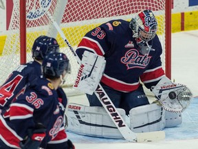 Regina Pats netminder Max Paddock gloves a shot during WHL action against the Saskatoon Blades at the Brandt Centre on Saturday.