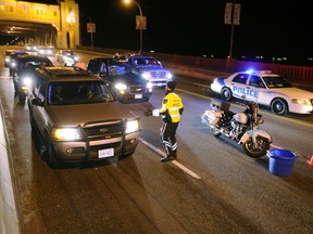 Members of the Vancouver Police Dept. conduct a road check on the Burrard Bridge in Vancouver, on New Year's Eve, December 31, 2010.