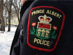 An officer wearing a Prince Albert police badge.