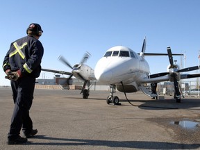 A member of the ground crew personnel readies a West Wind Aviation plane at the Shell Aero Centre for a flight to Saskatoon.