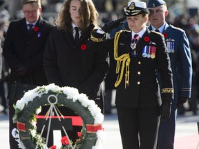 Governor General Julie Payette places a wreath with her son Laurier Payette-Flynn during Remembrance Day ceremonies at the National War Memorial in Ottawa on Sunday, Nov. 11, 2018. Some of Canada's top military historians say the federal government missed an important opportunity to commemorate the First World War's centenary, and that its efforts over the past four years paled in comparison to those of Britain, Australia and others.