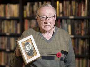 Clint White holds up a portrait of himself when he was in the service in Regina.