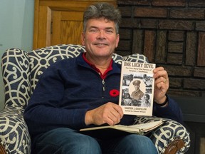 Edward Willett holds a copy of a book he recently published, the memoirs of his wife's grandfather Sampson J. Goodfellow. Goodfellow was a truck driver and navigator during the First World War in the Canadian Expeditionary Force and Royal Flying Corps.