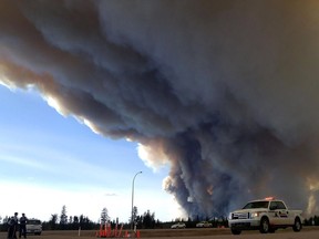 In this image released by the Alberta Royal Canadian Mounted Police, members of the RCMP monitor the Fort McMurray Wildfire, on May 7, 2016.