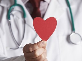 Close Up Of Doctor Holding Cardboard Heart