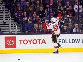 Noah Hanifin of the Calgary Flames celebrates one of the 15 goals that were scored Tuesday when his team defeated the host Columbus Blue Jackets 9-6.