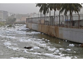 In this Monday, Dec. 10, 2018 photo toxic froth from industrial pollution floats on Bellundur Lake in Bangalore, India. As politicians haggle at a U.N. climate conference in Poland over ways to limit global warming, the industries and machines powering our modern world keep spewing their pollution into the air and water. The fossil fuels extracted from beneath the earth's crust _ coal, oil and gas _ are transformed into the carbon dioxide that is now heating the earth faster than scientists had expected even a few years ago.