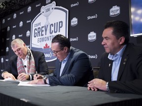 CFL Commissioner Randy Ambrosie, left, and Oscar Perez, Chief Executive Officer of the LFA sign a letter of intent as Alejandro Jaimes, Commissioner of the LFA looks on following the State of the League news conference at Grey Cup week in Edmonton, Friday, November 23, 2018.