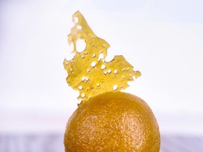 Detail of cannabis oil (aka shatter) and live resin in a ball shape isolated against white background