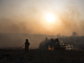 Lumsden volunteer firefighters, along with many local residents and businesses, all pitch in fighting a grass fire near Lumsden.